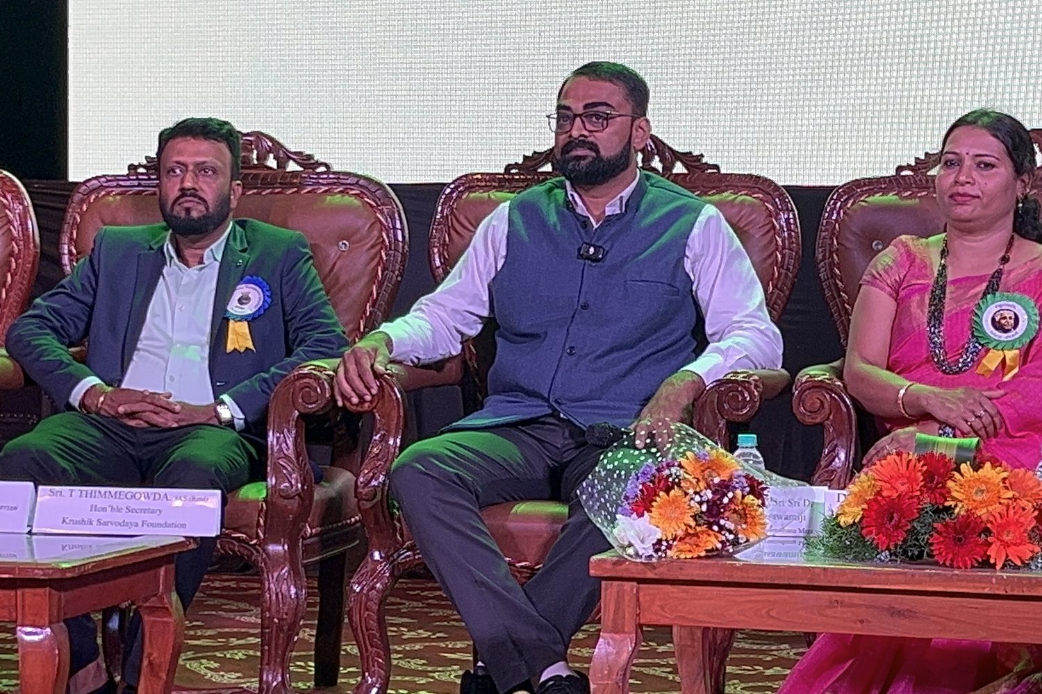 On the dais beside Sri T. Thimmegowda, IAS (Retd.) — Dr Varun Murthy